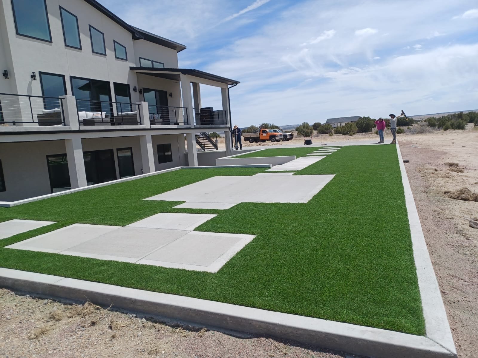 Modern Colorado Springs backyard with artificial turf and a concrete paver ribbon design